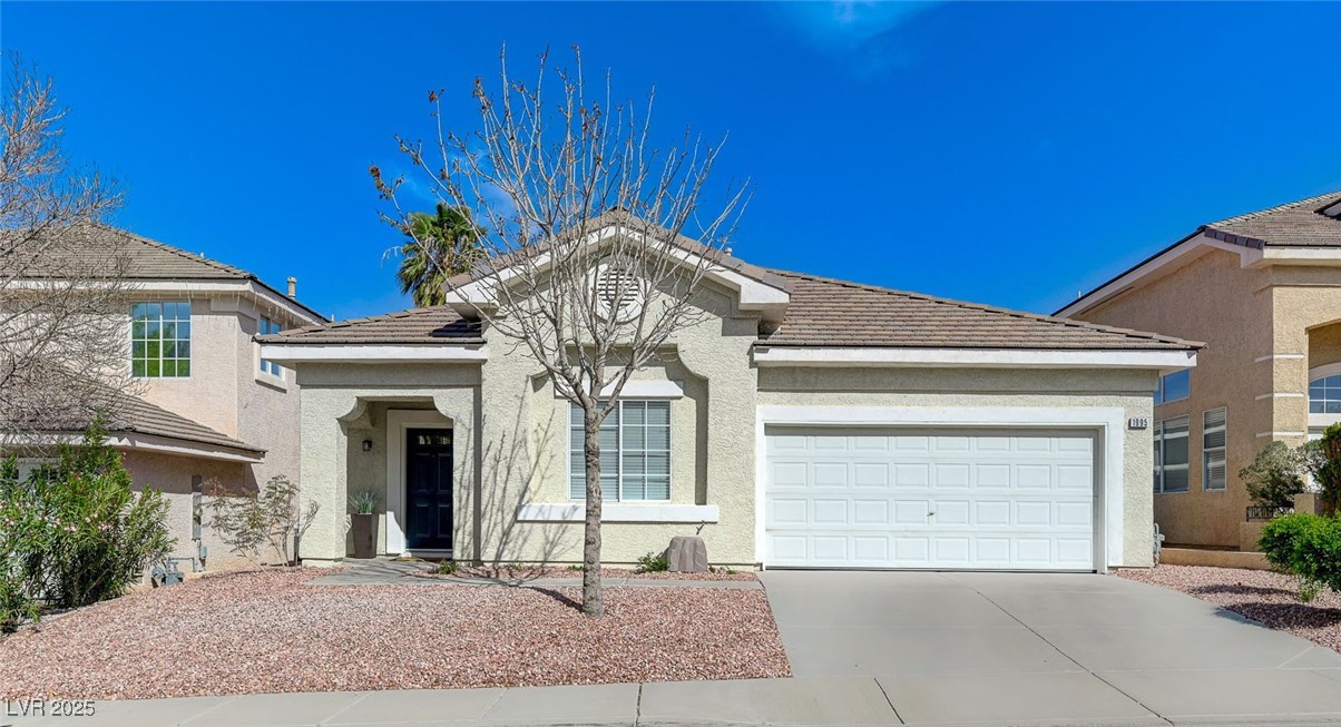 1995 Thunder Ridge Circle Henderson, NV 89012 - Photo 1 of 47 Single story home featuring driveway, stucco siding, and an attached garage