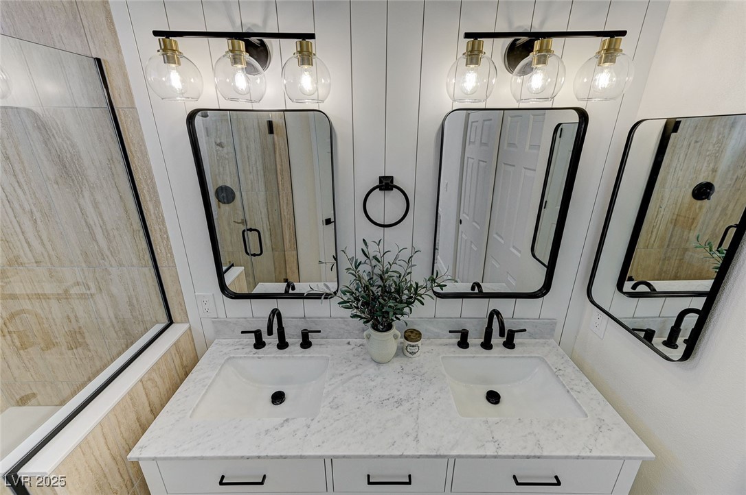 1995 Thunder Ridge Circle Henderson, NV 89012 - Photo 27 of 47 Full bathroom with double vanity, a sink, and a stall shower