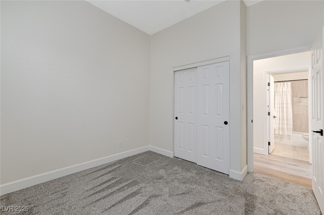 1995 Thunder Ridge Circle Henderson, NV 89012 - Photo 30 of 47 Unfurnished bedroom featuring carpet floors, baseboards, and a closet