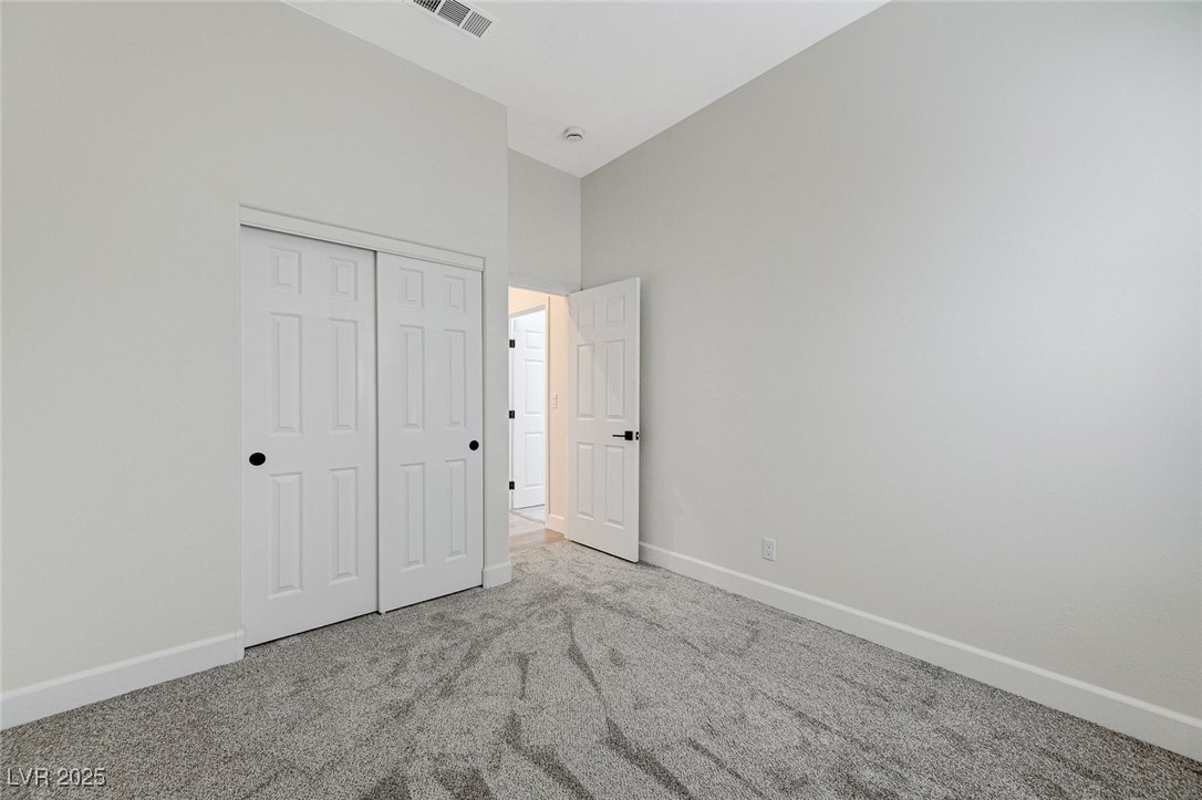 1995 Thunder Ridge Circle Henderson, NV 89012 - Photo 31 of 47 Unfurnished bedroom featuring baseboards, visible vents, a closet, and carpet