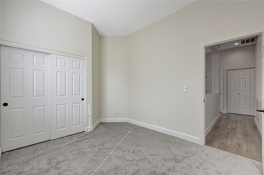 1995 Thunder Ridge Circle Henderson, NV 89012 - Photo 36 of 47 Unfurnished bedroom with baseboards, carpet floors, visible vents, and a closet