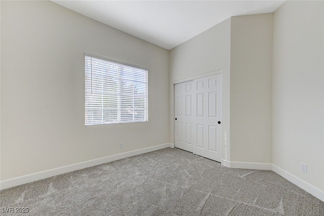 1995 Thunder Ridge Circle Henderson, NV 89012 - Photo 37 of 47 Unfurnished bedroom with carpet floors, baseboards, and a closet