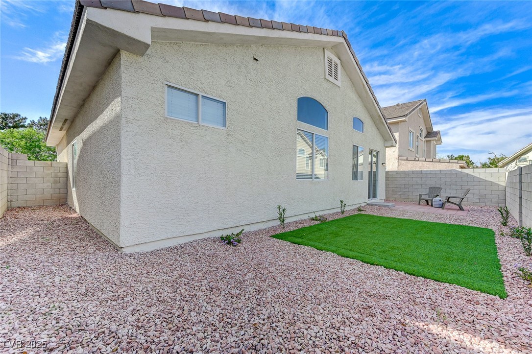 1995 Thunder Ridge Circle Henderson, NV 89012 - Photo 41 of 47 Back of house featuring a fenced backyard, stucco siding, and a patio