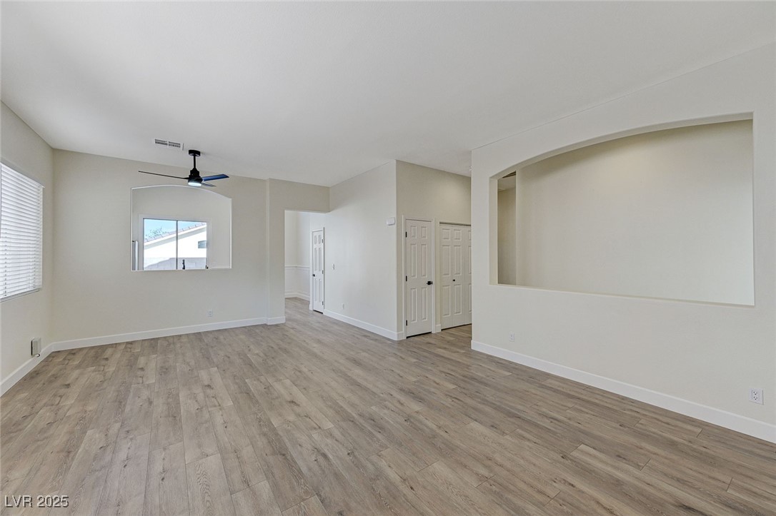 1995 Thunder Ridge Circle Henderson, NV 89012 - Photo 5 of 47 Unfurnished room with baseboards, visible vents, light wood-style floors, and a ceiling fan