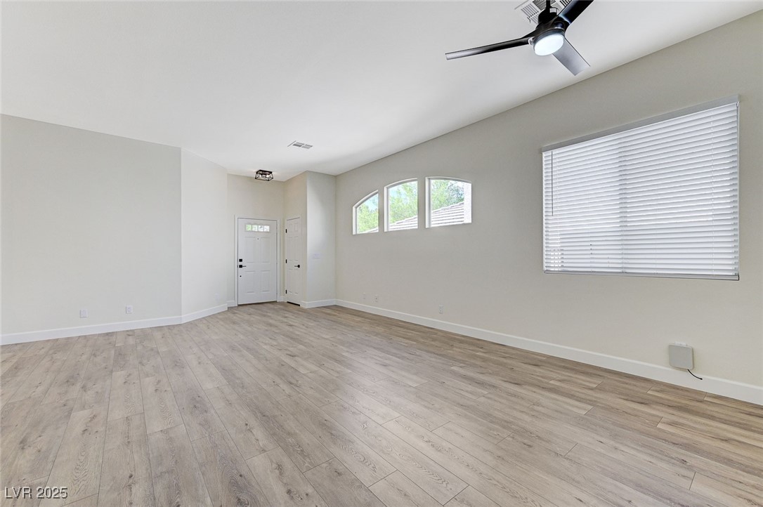 1995 Thunder Ridge Circle Henderson, NV 89012 - Photo 6 of 47 Empty room with a ceiling fan, baseboards, light wood-style floors, and visible vents