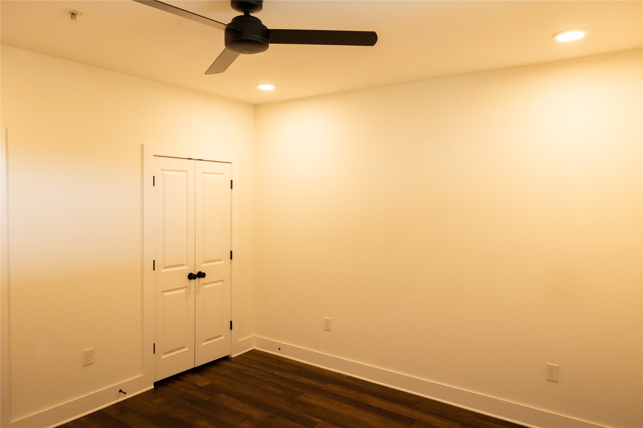 4704 Sunset Trail, Unit 1203 Austin, TX 78745 - Photo 11 of 26 Unfurnished room featuring dark wood-type flooring, ceiling fan, and recessed lighting
