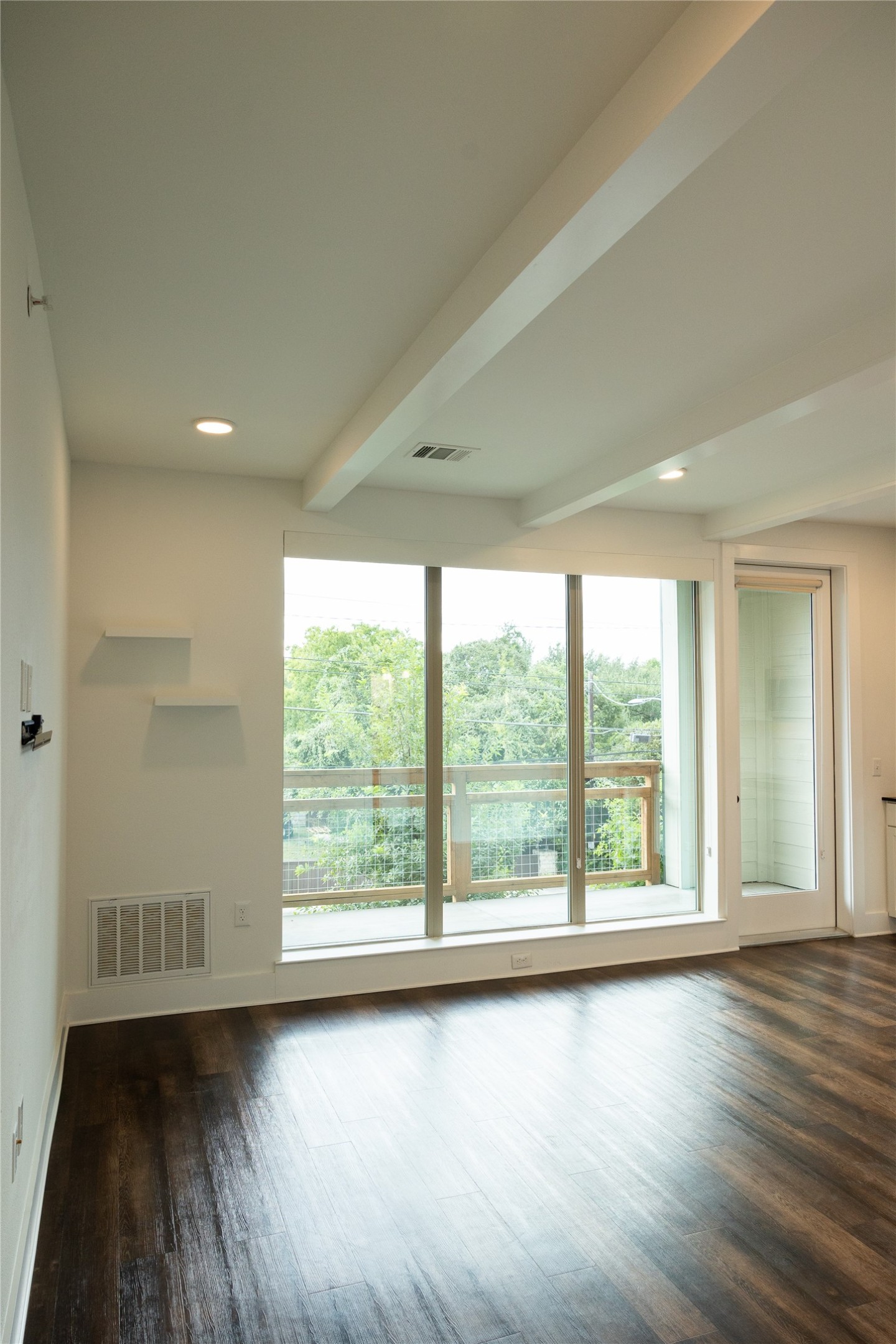 4704 Sunset Trail, Unit 1203 Austin, TX 78745 - Photo 16 of 26 Empty room featuring beam ceiling, dark wood finished floors, and recessed lighting