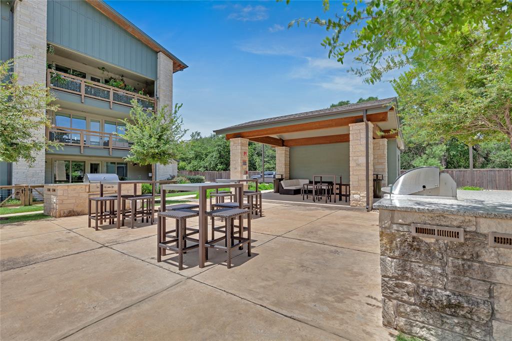 4704 Sunset Trail, Unit 1203 Austin, TX 78745 - Photo 17 of 26 View of patio / terrace featuring area for grilling and an outdoor bar and dining area