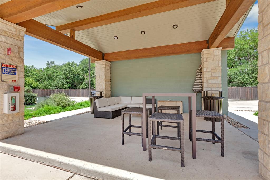 4704 Sunset Trail, Unit 1203 Austin, TX 78745 - Photo 18 of 26 View of patio featuring an outdoor living space with a fireplace