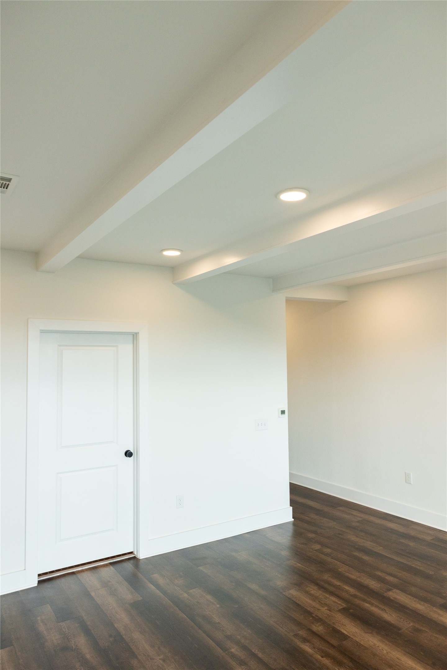 4704 Sunset Trail, Unit 1203 Austin, TX 78745 - Photo 6 of 26 Unfurnished room featuring beam ceiling, dark wood finished floors, and recessed lighting