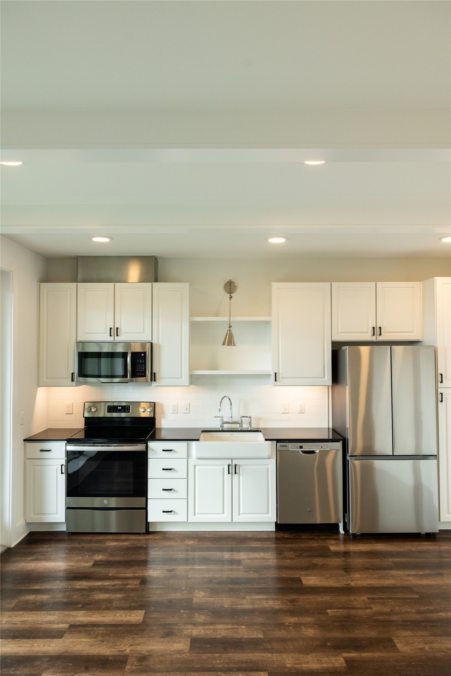 4704 Sunset Trail, Unit 1203 Austin, TX 78745 - Photo 9 of 26 Kitchen with white cabinetry, stainless steel appliances, recessed lighting, open shelves, and dark wood-style floors