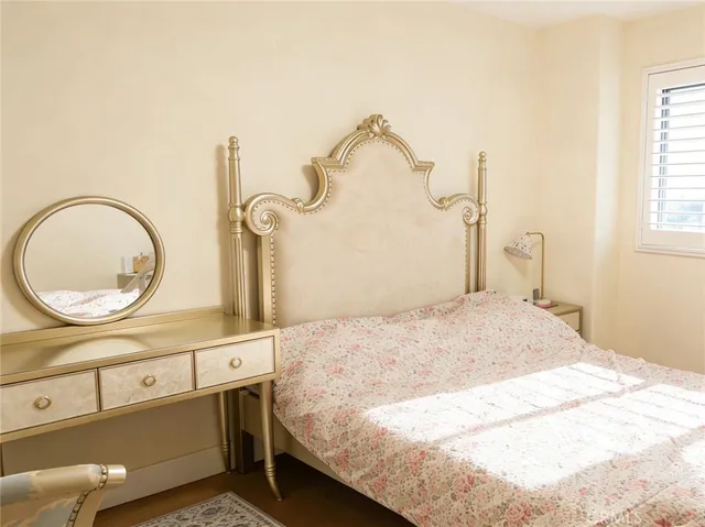 a bedroom with a bed and a mirror