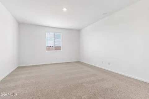 a view of an empty room with a kitchen