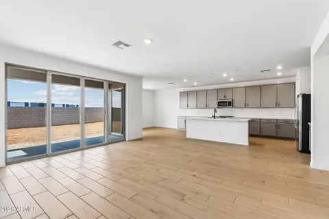 a large white kitchen with a sink and cabinets