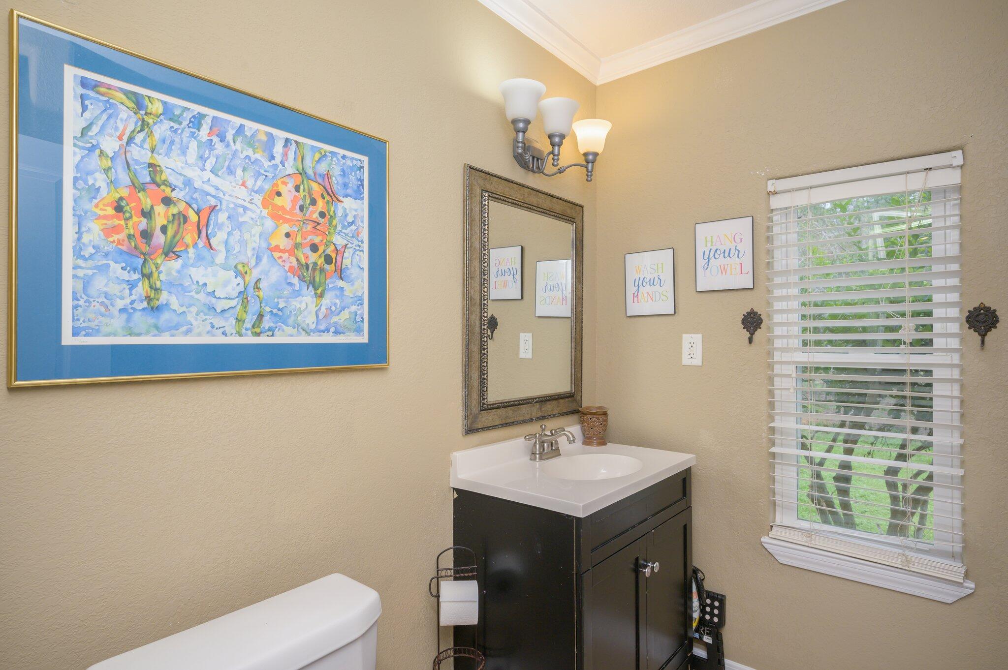 233 Rich's Road DeFuniak Springs, FL 32433 - Photo 25 of 45 a bathroom with a sink mirror and a toilet