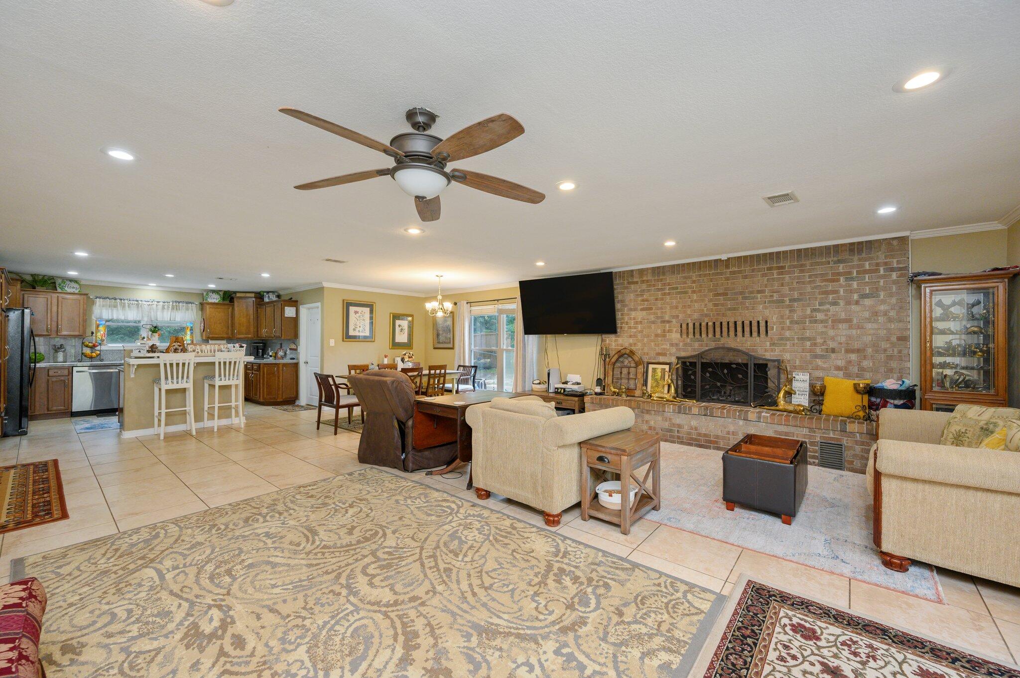 233 Rich's Road DeFuniak Springs, FL 32433 - Photo 8 of 45 a living room with furniture fireplace and a view of kitchen