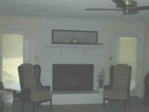 8065 Fairfield Forest Road Denver, NC 28037 - Photo 6 of 8 a living room with furniture and a fireplace