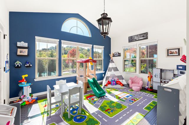 a spacious bedroom with a bed and a large window