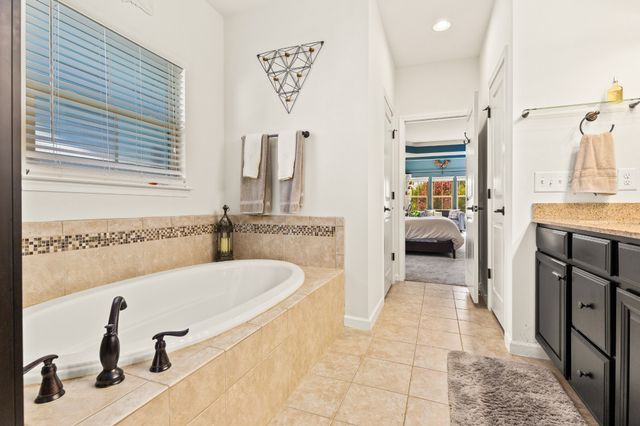 a bedroom with a bed and a desk in it