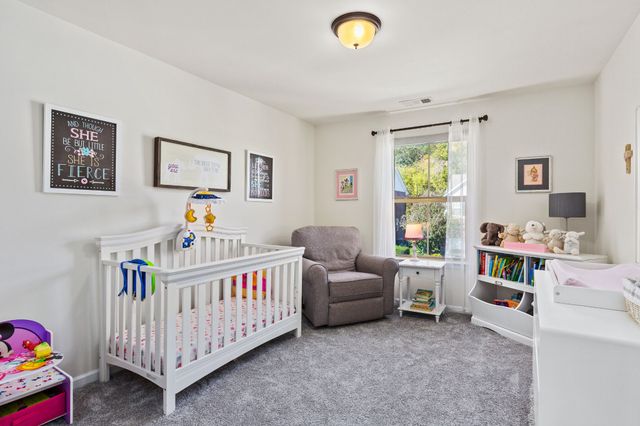 a room with wooden floor and a rug