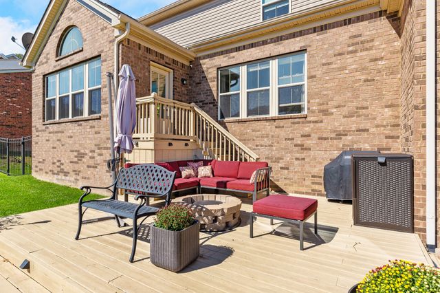 a view of a house with a yard and sitting area