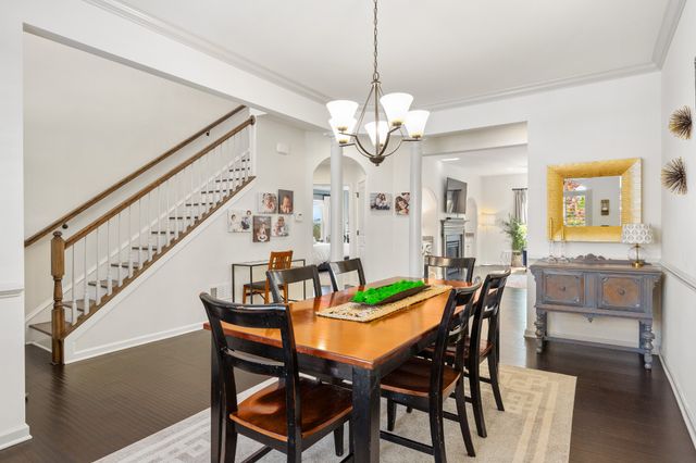 a view of a dining room with furniture and a chandelier