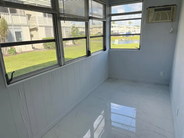 a view of an empty room and a window