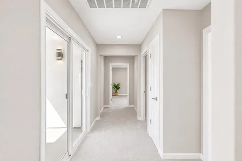 a large bed sitting in a bedroom next to a window