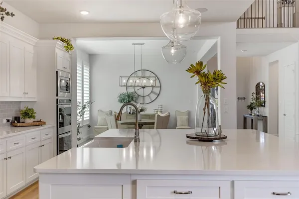 a kitchen with a sink and a chandelier