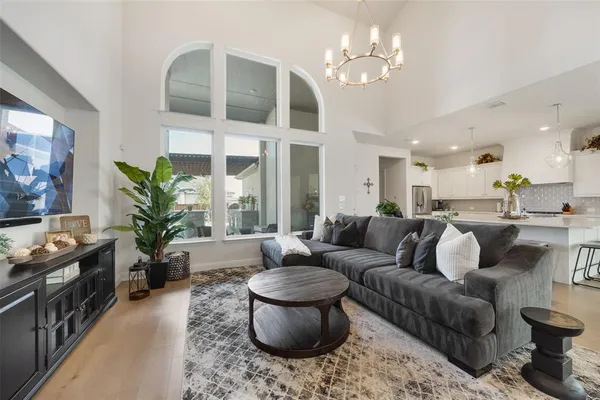 a living room with furniture or chandelier and a fireplace