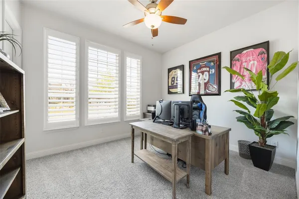 a work room with furniture and a potted plant
