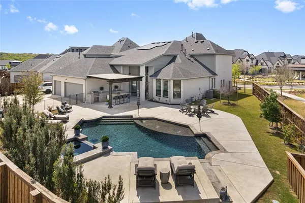 a view of a house with swimming pool and sitting area