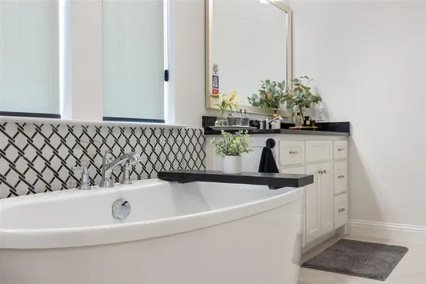 a bathroom with a bathtub and sink