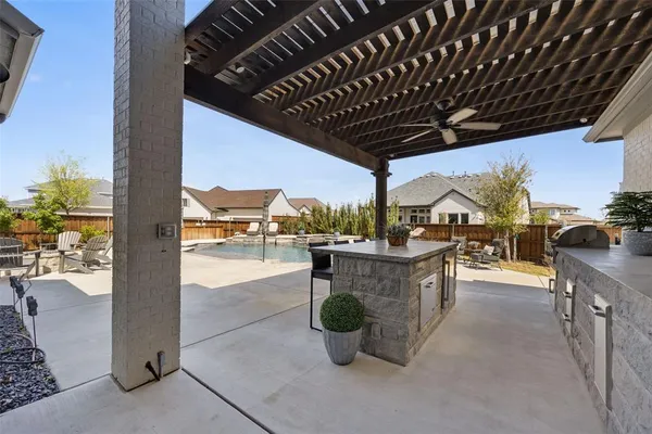 a view of a patio with a table and chairs potted plants