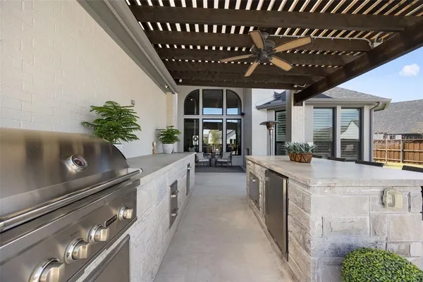 a kitchen with stainless steel appliances granite countertop a sink a stove and a wooden floors