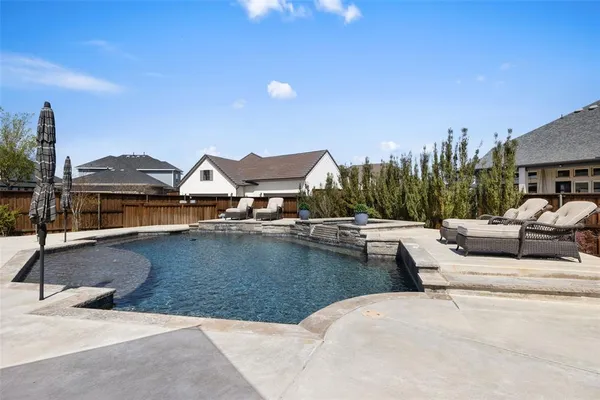 a view of a swimming pool and lounge chairs