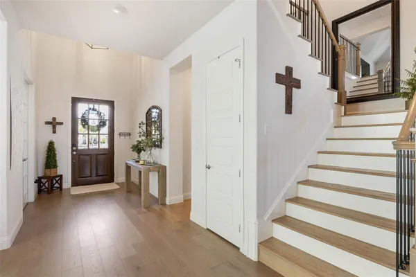 a view of a hallway with wooden floor and windows