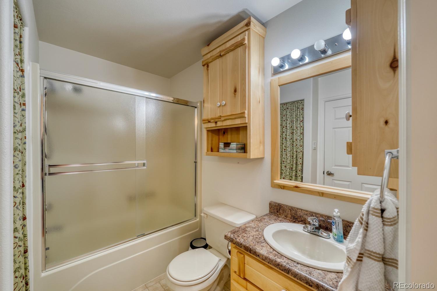 31015 West Ridge Road Buena Vista, CO 81211 - Photo 12 of 48 a bathroom with a sink granite tub toilet and a mirror