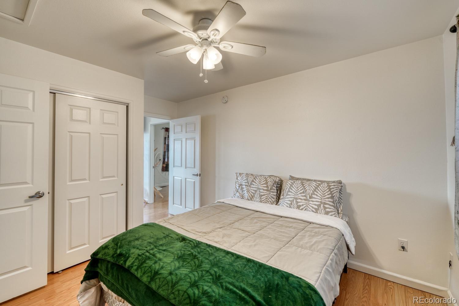 31015 West Ridge Road Buena Vista, CO 81211 - Photo 13 of 48 a bedroom with a bed and a chandelier