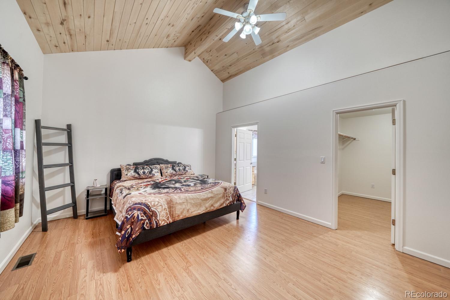 31015 West Ridge Road Buena Vista, CO 81211 - Photo 15 of 48 a bedroom with a bed and a wooden floor