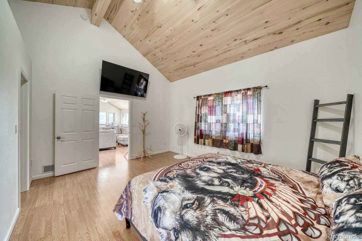 31015 West Ridge Road Buena Vista, CO 81211 - Photo 16 of 48 a bedroom with a bed and a television