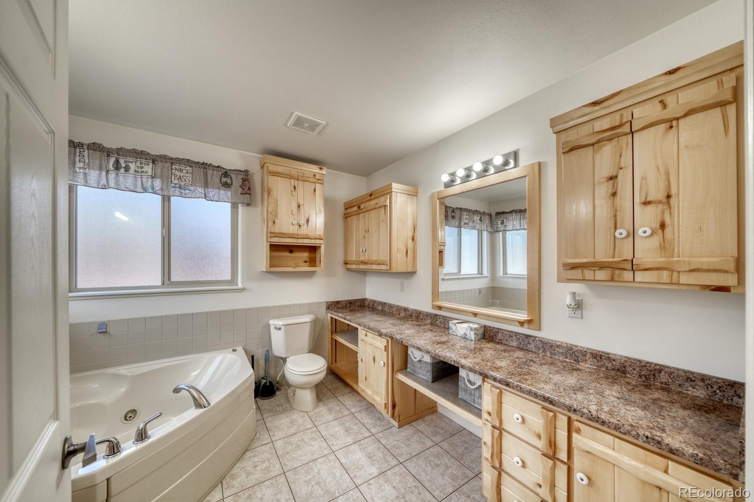 31015 West Ridge Road Buena Vista, CO 81211 - Photo 17 of 48 a large bathroom with a granite countertop tub sink and mirror