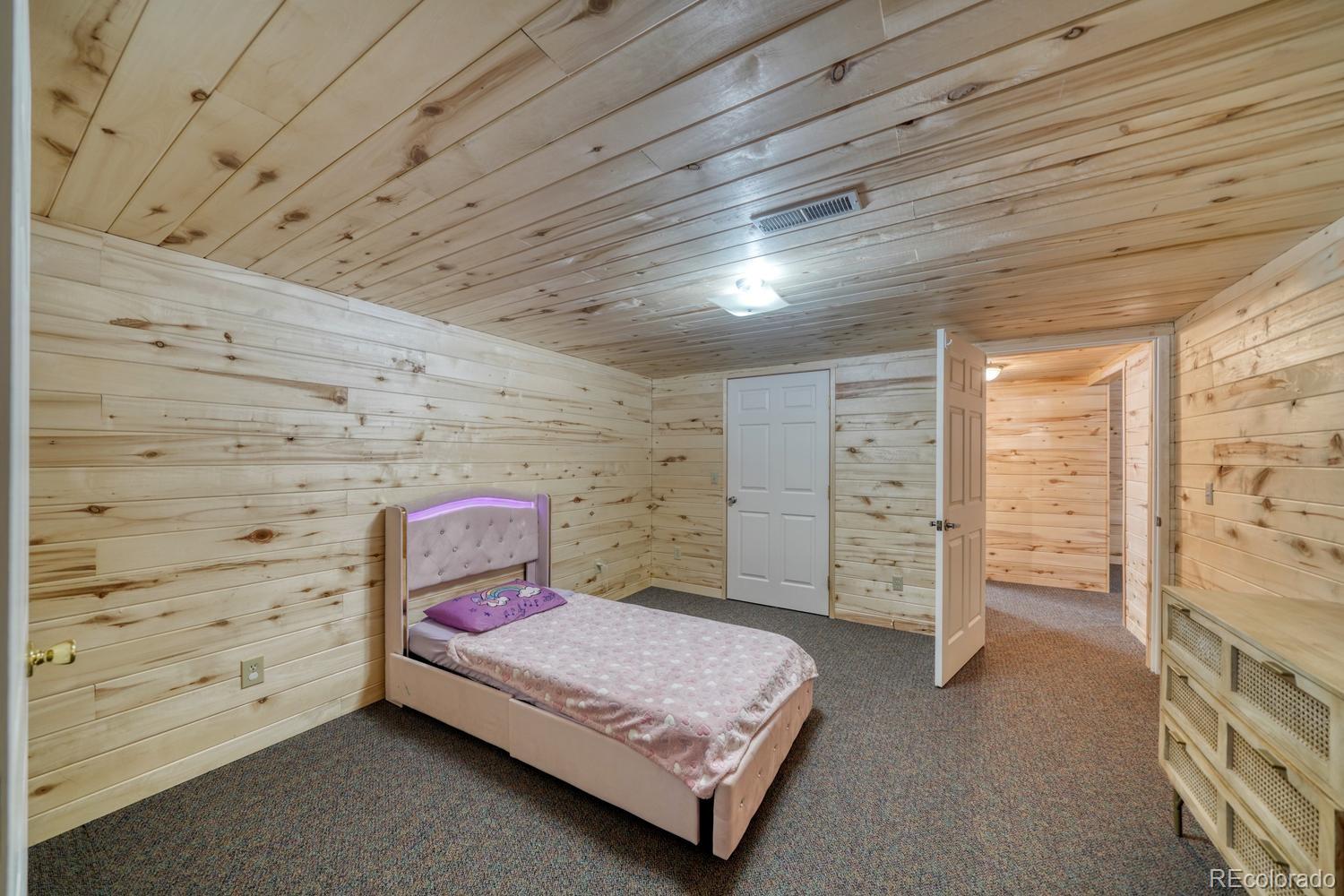 31015 West Ridge Road Buena Vista, CO 81211 - Photo 24 of 48 a bedroom with a bed and a walk in closet