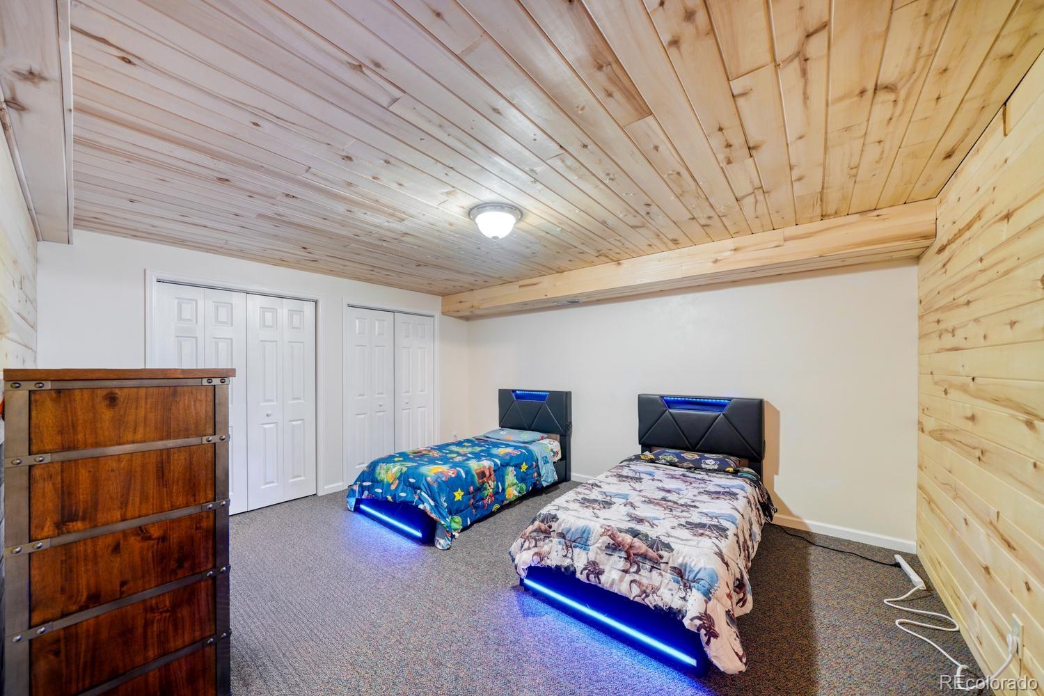 31015 West Ridge Road Buena Vista, CO 81211 - Photo 25 of 48 a bedroom with two beds and painted walls