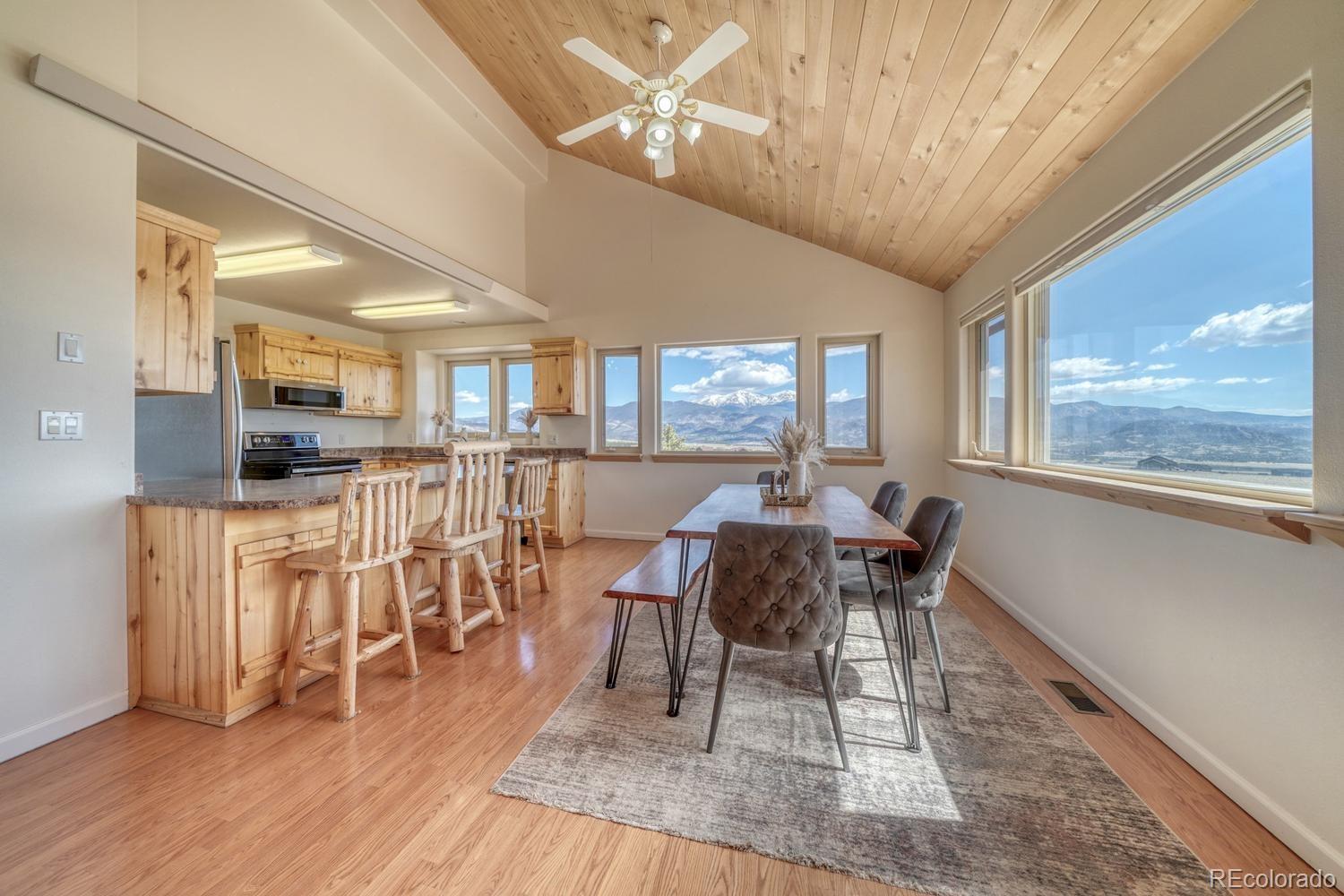 31015 West Ridge Road Buena Vista, CO 81211 - Photo 27 of 48 a dining room with furniture a chandelier and wooden floor