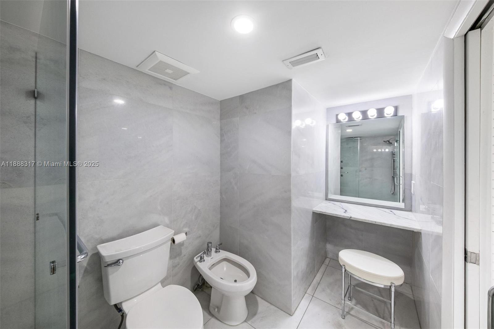 520 Brickell Key Drive, Unit A710 Miami, FL 33131 - Photo 11 of 43 a white toilet sitting next to a bathroom sink