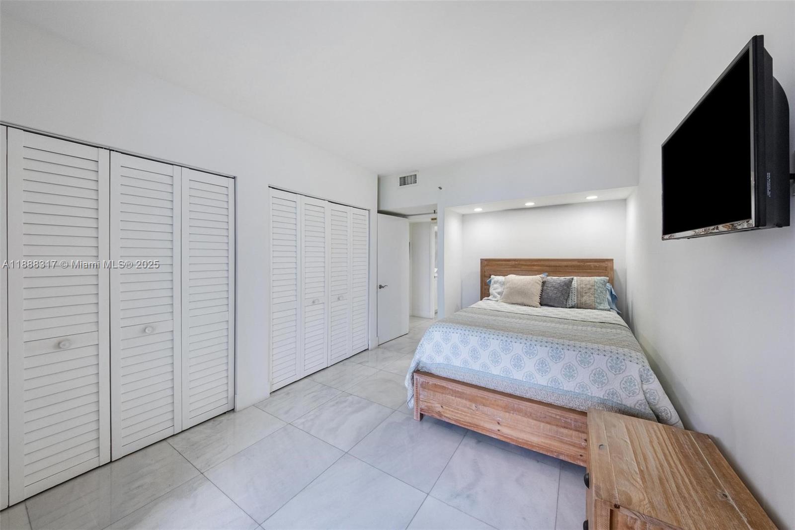 520 Brickell Key Drive, Unit A710 Miami, FL 33131 - Photo 14 of 43 a bedroom with a bed and a flat screen tv