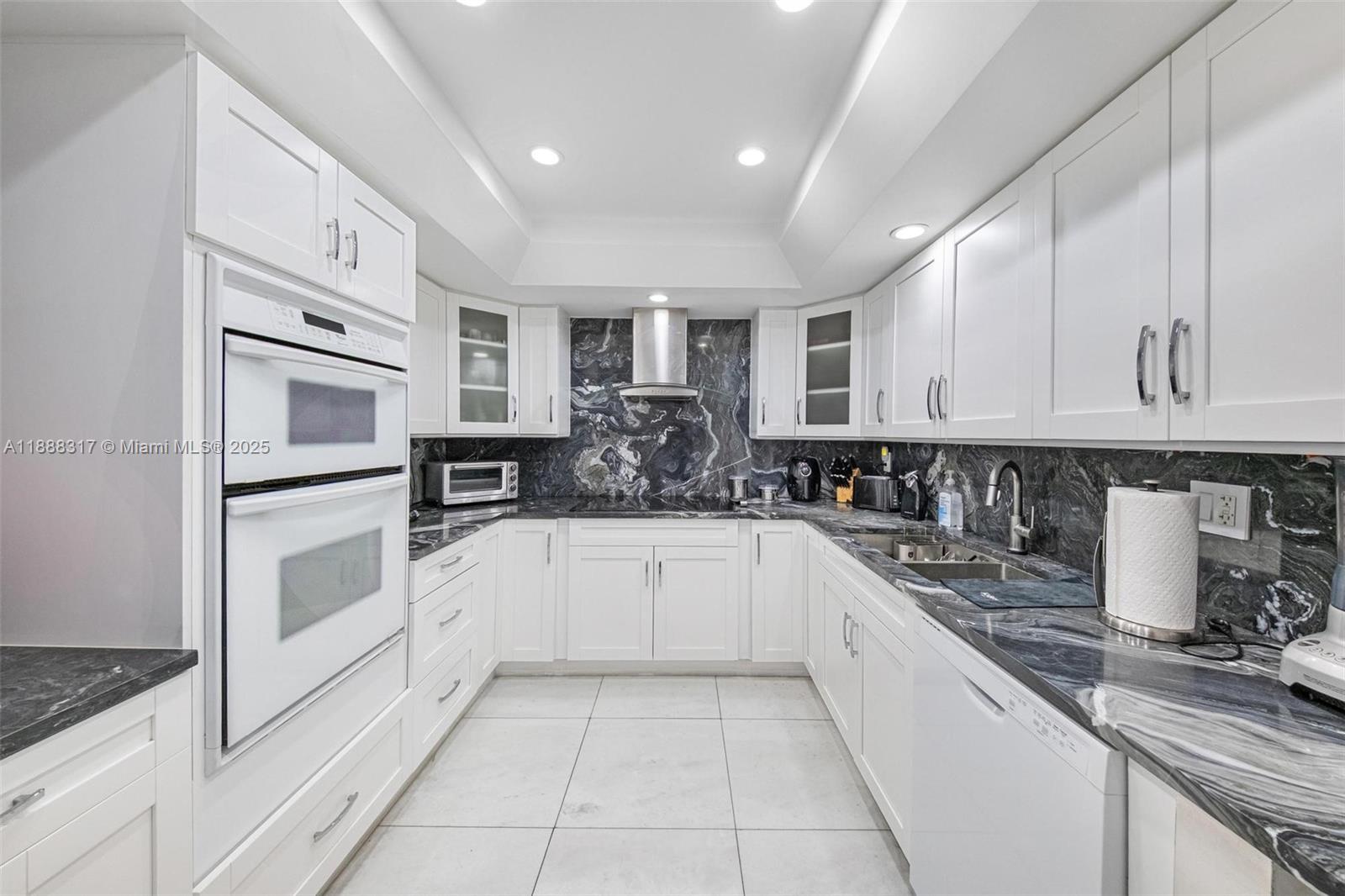 520 Brickell Key Drive, Unit A710 Miami, FL 33131 - Photo 16 of 43 a kitchen with stainless steel appliances granite countertop a refrigerator and a stove top oven
