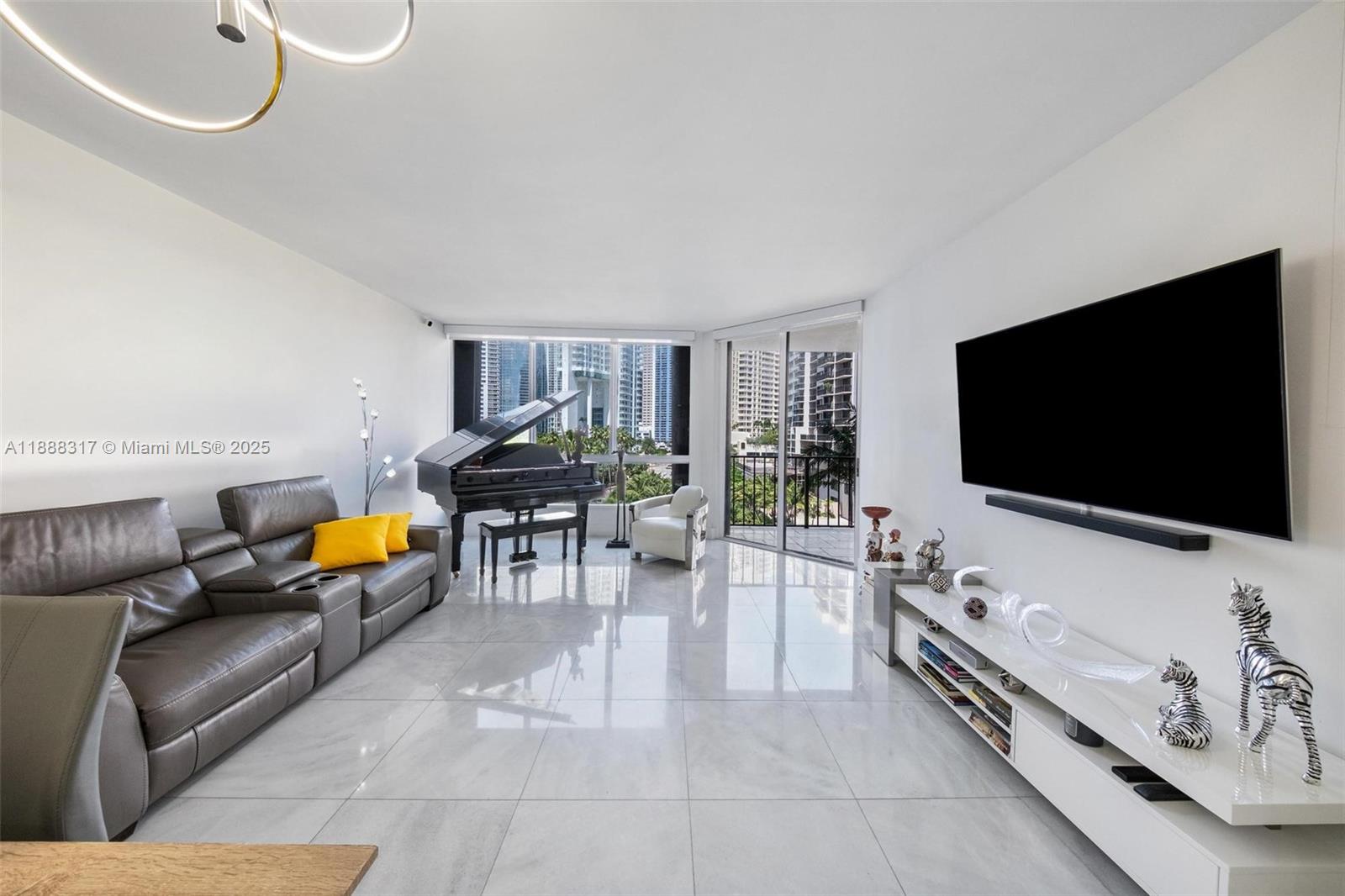 520 Brickell Key Drive, Unit A710 Miami, FL 33131 - Photo 20 of 43 a living room with furniture and a flat screen tv