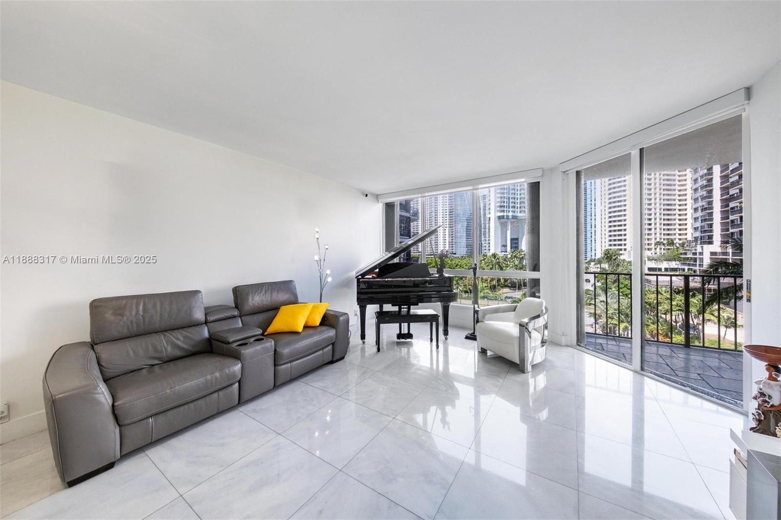 520 Brickell Key Drive, Unit A710 Miami, FL 33131 - Photo 21 of 43 a living room with furniture and a large window